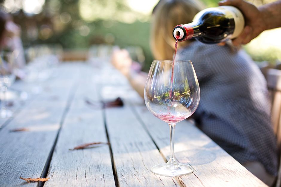 red wine glass vineyard italy